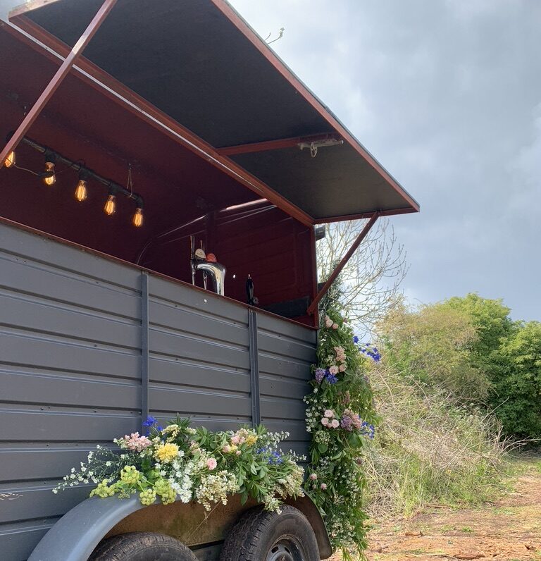 Mobile wedding bar with flowers